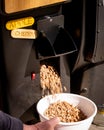 Man demonstrates emptying the hopper of a pellet smoker Royalty Free Stock Photo