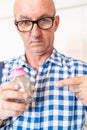 A man demonstrates a tube with a valve and a hinged connection for intravenous fluid injections to an implanted port for Royalty Free Stock Photo