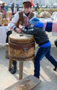 Man demonstrates work of old hand-made mill to boy during Shrovetide entertainment program Royalty Free Stock Photo