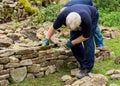 Man demonstrating building a Dry Stone Wall. Royalty Free Stock Photo