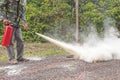 A man demonstrating how to use a fire extinguisher