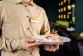 dessert pancake in the hands of a waiter in a cafe Royalty Free Stock Photo
