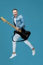 Man in denim t-shirt jeans with guitar jumping Royalty Free Stock Photo