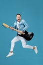 Man in denim t-shirt jeans with guitar jumping Royalty Free Stock Photo