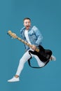 Man in denim t-shirt jeans with guitar jumping Royalty Free Stock Photo