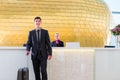 Man departing on business trip at hotel reception Royalty Free Stock Photo