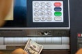 Man deposits a hundred dollar bill at a drive-thru ATM at a bank Royalty Free Stock Photo