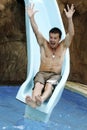 Man descending a water slide Royalty Free Stock Photo