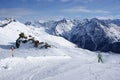 A man descends from the mountain in the Alps skiing with a steep slope Royalty Free Stock Photo