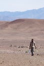 Man in desert carrying water Royalty Free Stock Photo