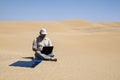 Man in the desert with flexible solar charger with copy space