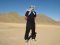 Man in desert with keffiyeh