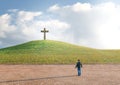 Man in the desert seeking salvation by faith in Jesus Christ looking at the cross. Biblical concept of Christianity Royalty Free Stock Photo