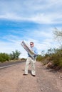 Man on deserted road reading map Royalty Free Stock Photo