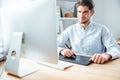 Man designer working using computer and graphic tablet at workplace Royalty Free Stock Photo