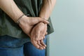 Man detained in handcuffs indoors. Criminal law Royalty Free Stock Photo