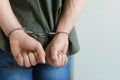 Man detained in handcuffs indoors. Criminal law Royalty Free Stock Photo