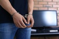 Man detained in handcuffs indoors. Criminal law Royalty Free Stock Photo