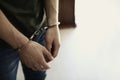 Man detained in handcuffs indoors. Criminal law Royalty Free Stock Photo