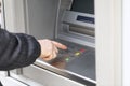 Man dials PIN code to withdraw money from ATM Royalty Free Stock Photo