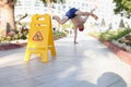 Man didnt notice yellow sign of wet floor plate near swimming pool