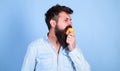 Man diet nutrition eats fruit. Man handsome hipster with long beard eating apple. Hipster hungry bites juicy ripe apple