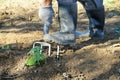 Man digging garden with a garden fork