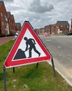 Man digging silhouette road works sign