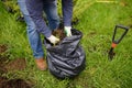 Man diging holes a shovel for planting juniper plants in the yard or garden. Landscape design