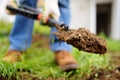 Man diging holes a shovel for planting juniper plants in the yard or garden. Landscape design