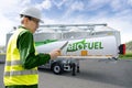 Man with digital tablet on a background of tank trailer with biofuel. Royalty Free Stock Photo