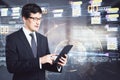 Man with digital tablet in hand on the background of abstract programming language, online coding concept
