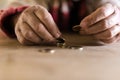 Man with dirty hands sitting at his desk counting coins Royalty Free Stock Photo