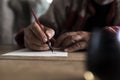 A man with dirty hands writing on a sheet of paper Royalty Free Stock Photo