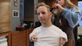 a man with disabilities gets his hair cut and styled in a barber shop.