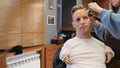 a man with disabilities gets his hair cut and styled in a barber shop.