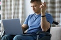 Man with disability is sitting on stroller laptop Royalty Free Stock Photo