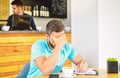 Man disappointed desperate face sit cafe with mug of coffee and notepad. Headache and stress. Crisis in creativity and Royalty Free Stock Photo