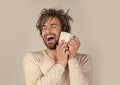 Man with disheveled hair drink coffee or milk. Happy guy with tea cup on grey background. Cold and flu