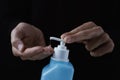 Man disinfecting his hands with hand sanitizer