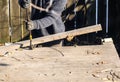 Man Dismantling an Old Wooden Deck with a Crowbar 1