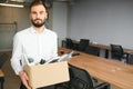 Man by dismissal. Guy lost job. Fired manager in company. Dismissal box in hands of employee. Royalty Free Stock Photo