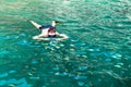 A man in the sea photographs a flock of colorful fish under water Royalty Free Stock Photo