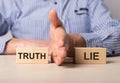Man divides blocks with words truth and lie. Confrontation between true and false information, news, actions. Choice Royalty Free Stock Photo