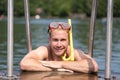 Man with diving goggles at public swimming pool