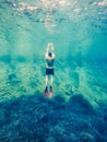 man in diving mask snorkeling in sea water