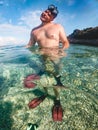 man in diving mask snorkeling in sea water