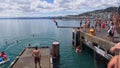 Man diving off a diving board into Hutt River at Wellington Harbor, New Zealand Royalty Free Stock Photo