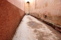 Man in djellaba walking in a orange brown street