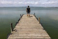 Man On A Dock By The Lake At morning Sky